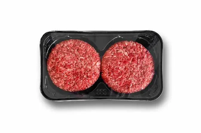 Two uncooked beef burgers presented on a tray