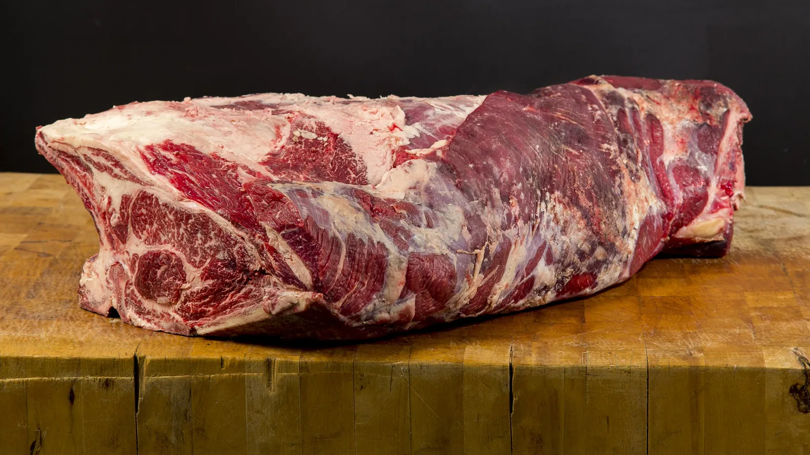 Whole uncooked beef loin on a butcher's table